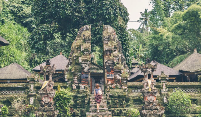 a solo female traveler visiting a temple in Southeast Asia