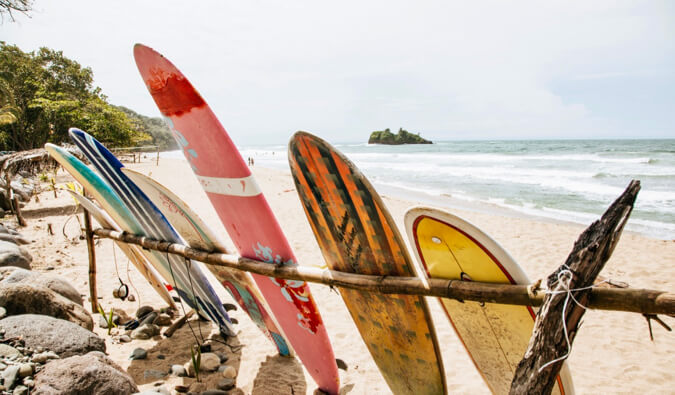 colorful surfboards resting on the beach in Costa Rica