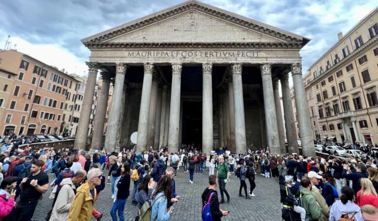 A huge crowd of tourists near the famous Pantheon in Paris, France in the summer