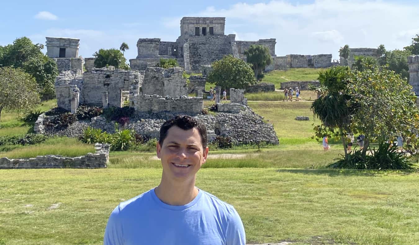 Nomadic Matt posing near the historic ruins of Tulum, Mexico