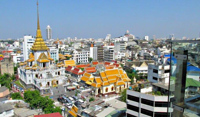 areal image of Bangkok with a temple to the left with a gold roof