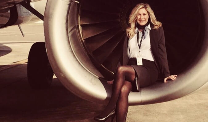 Flight attendant Heather Poole posing by an airplane