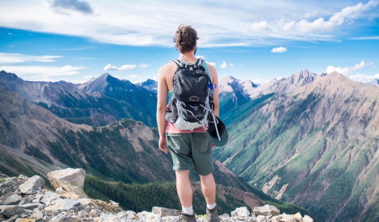 Man looking over a canyon on a sunny day