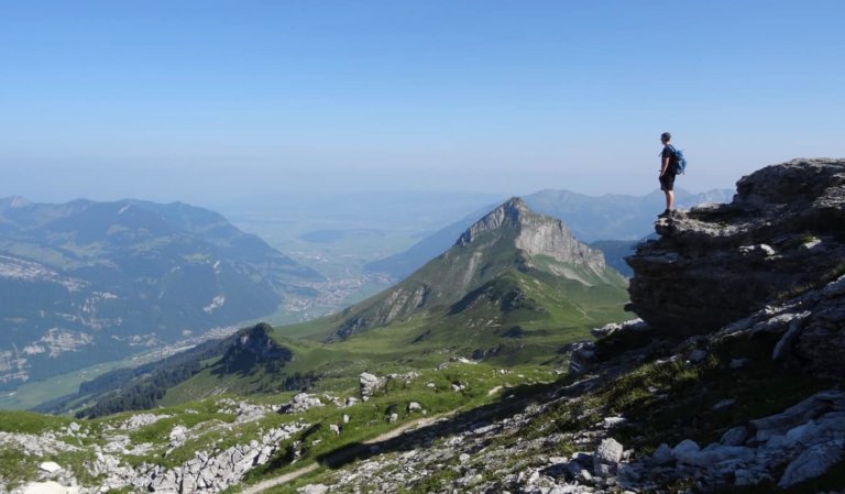 A solo traveler looking out over mountains