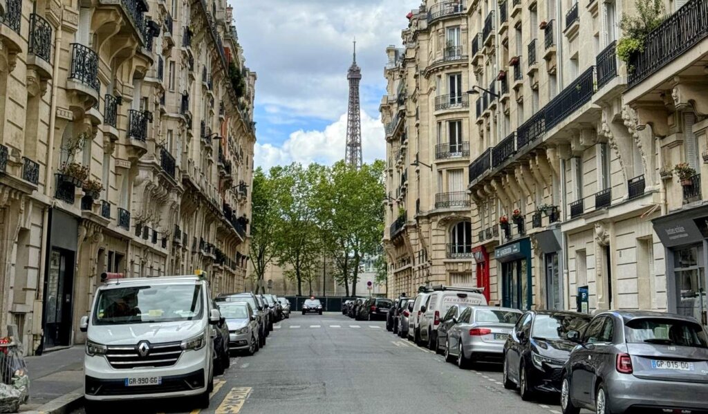 A streetscape in Paris, France, with the Eiffel Tower in the background