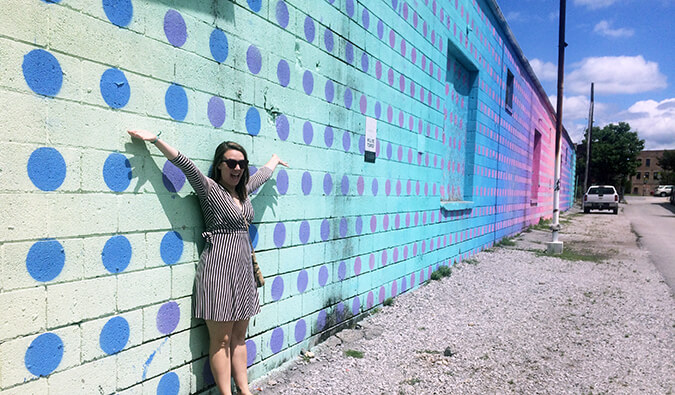 Caroline Eubanks standing in front of murals in Chattanooga, Tennessee