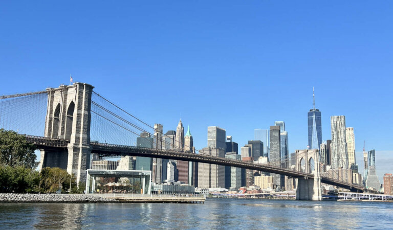A blue sky and sunny day overlooking the towering skyline of Manhattan, NYC