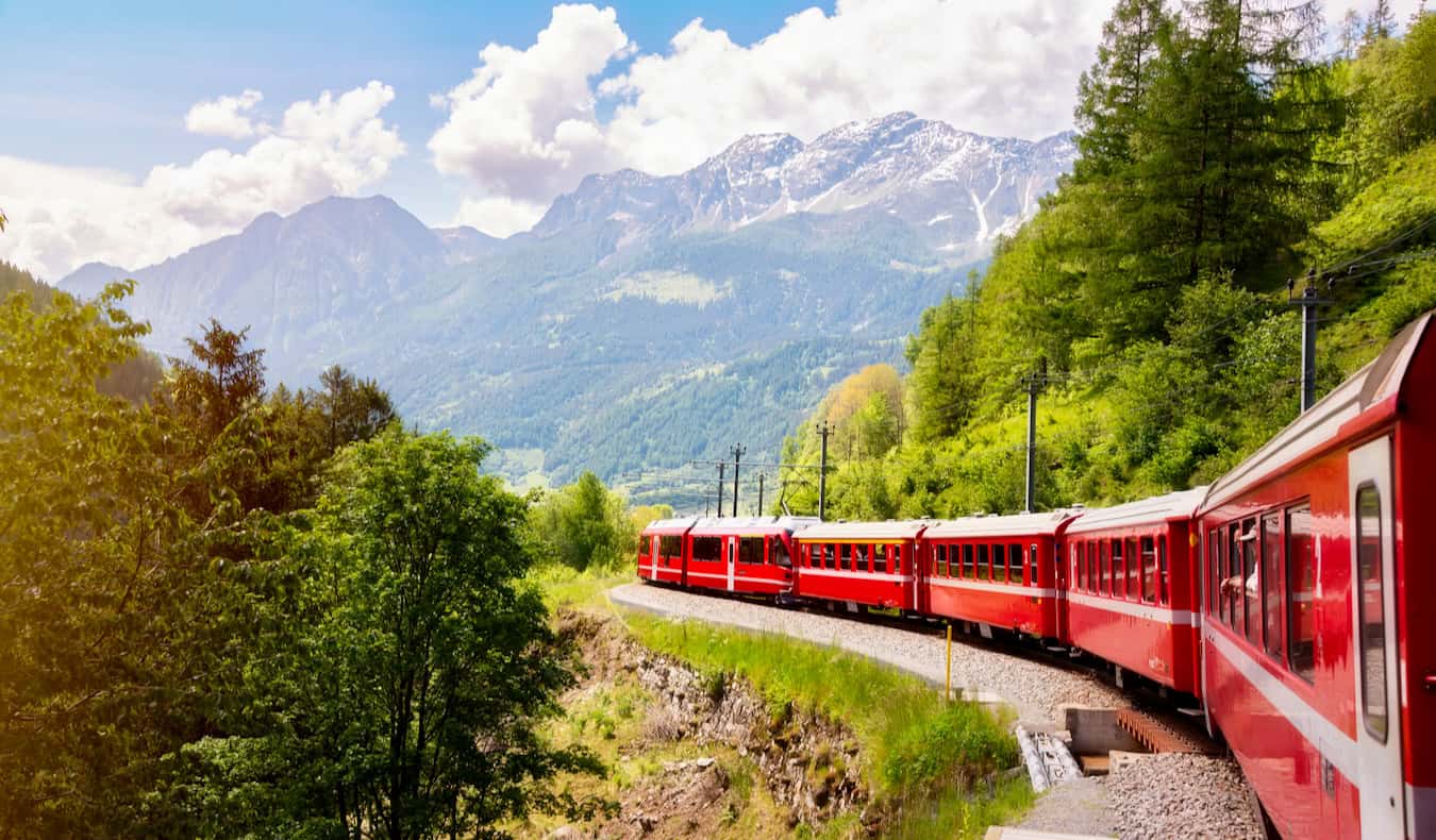 A train speeding through the mountains of Switzerland