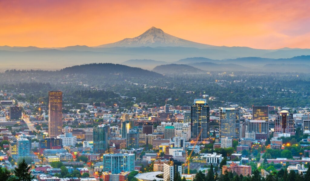 the skyline of Portland, Oregon, with Mt Hood in the background, at sunset