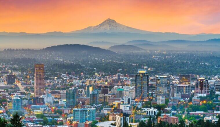 the skyline of Portland, Oregon, with Mt Hood in the background, at sunset