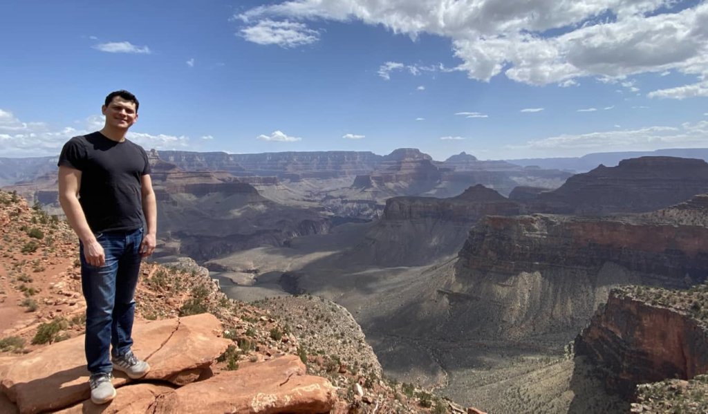 Nomadic Matt standing at the edge of the Grand Canyon