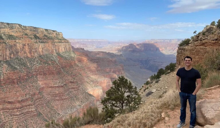 Nomadic Matt posing in front of the Grand Canyon