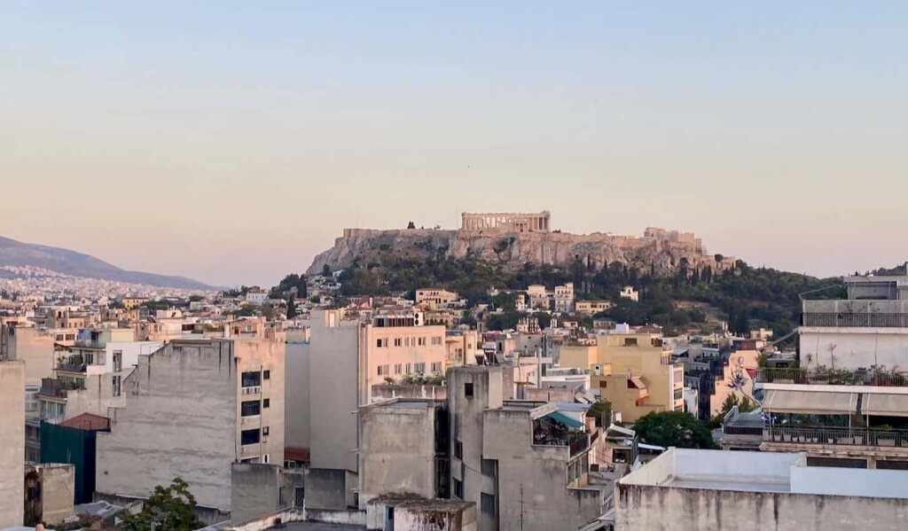 A pastel sunset overlooking the Acropolis in historic Athens, Greece