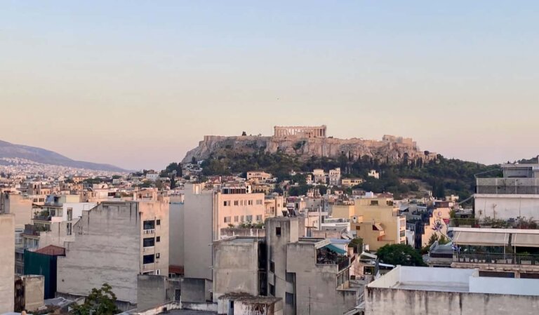 A pastel sunset overlooking the Acropolis in historic Athens, Greece