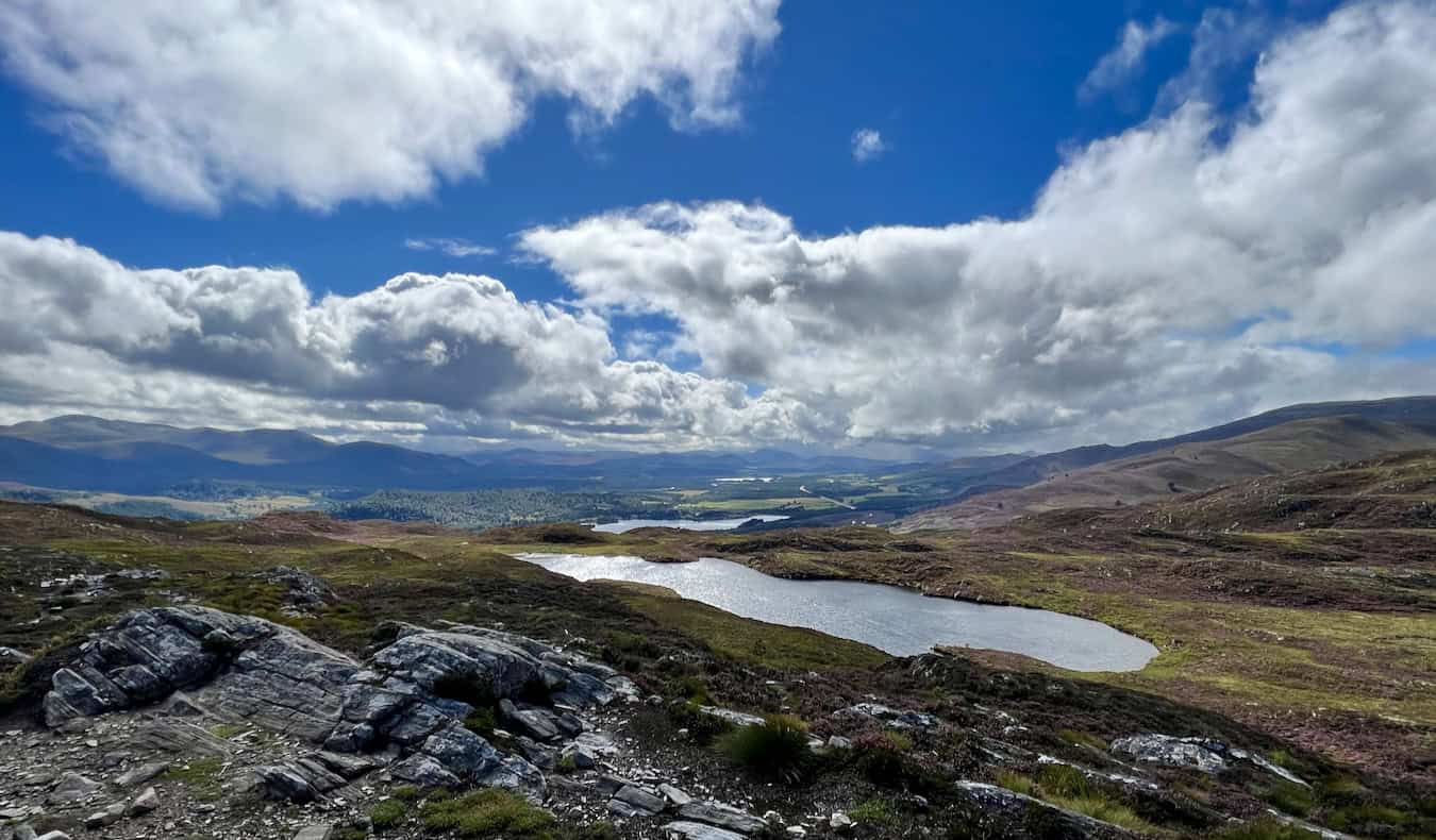 A beautiful blue sky over the rugged highlands of Scotland on a road trip