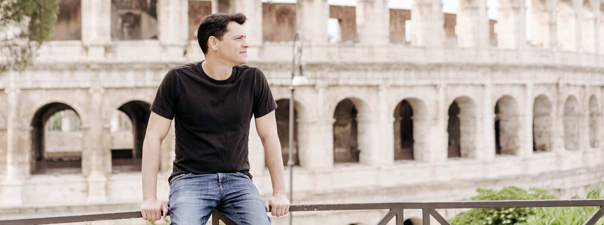 Nomadic Matt posing near the Colosseum in Rome, Italy